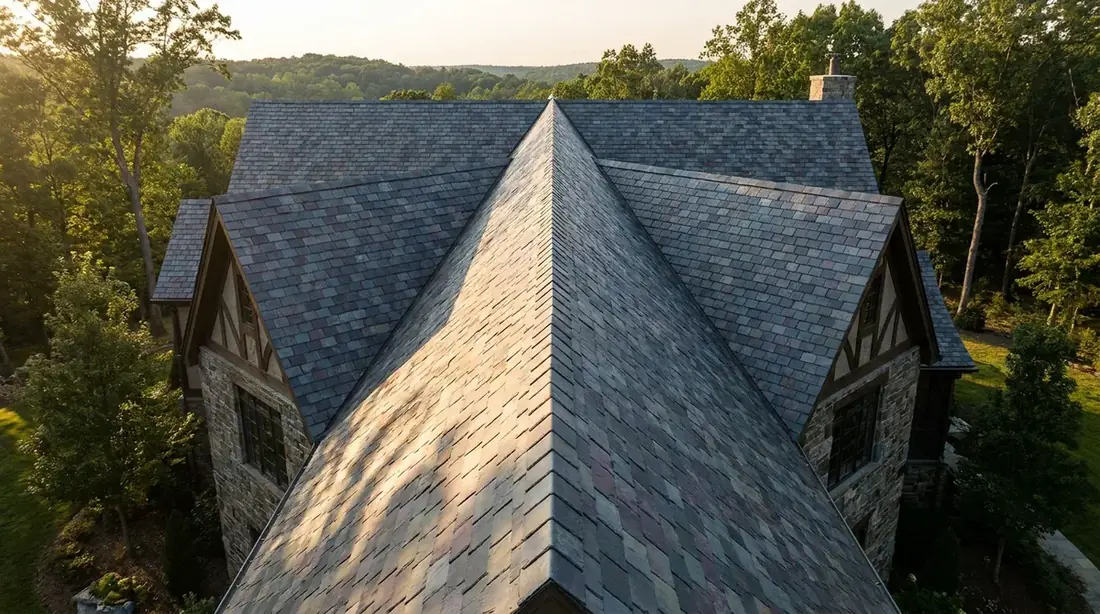 Natural slate residential roof, varied gray tones, in late-day sunlight